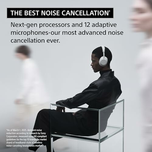 Person wearing noise-cancelling headphones sitting on a chair.