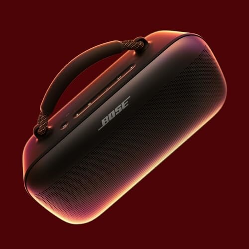 Portable Bose speaker with handle on a red background