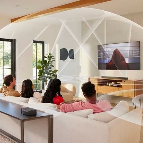 Family sitting on a sofa watching TV in a modern living room.