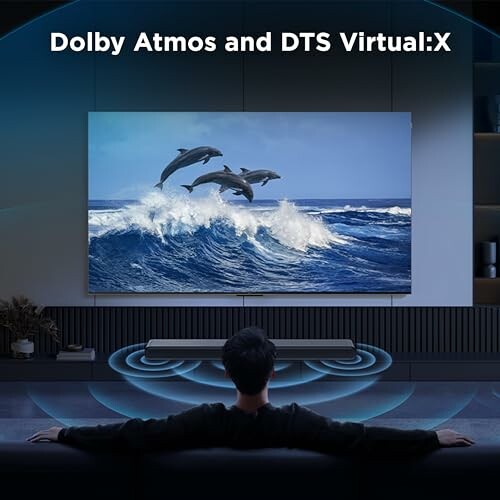 Person watching TV with Dolby Atmos and DTS Virtual:X sound.