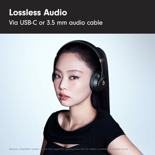 Person wearing headphones with text about lossless audio via USB-C or 3.5 mm cable.