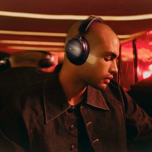 Man wearing headphones in a dimly lit room