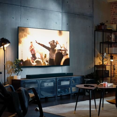 Living room with a large TV displaying a concert scene.