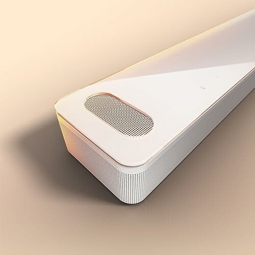 Modern white speaker on beige background