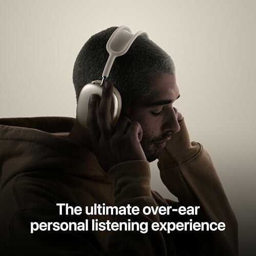 Person wearing over-ear headphones with eyes closed